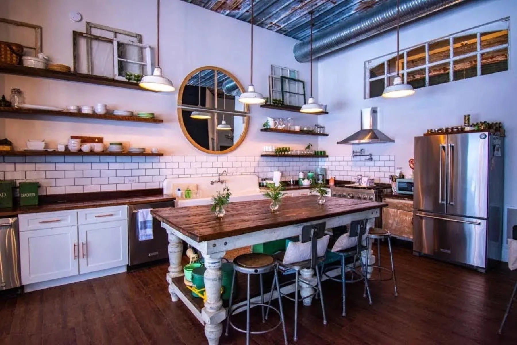 The Highbanks kitchen, white subway tile with open wood shelving and a stainless range
