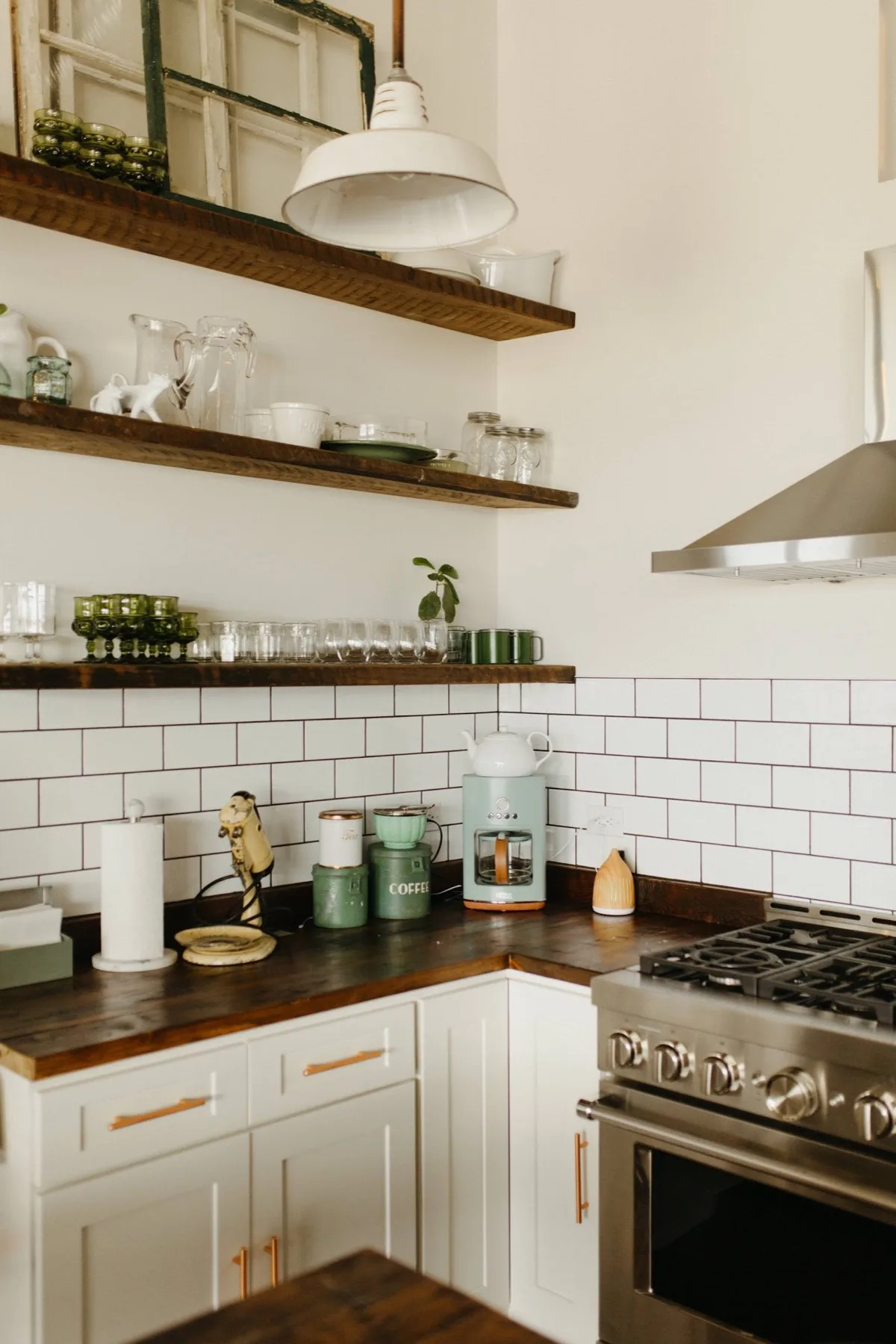 Coffee and pantry corner with open wood shelving, a dark counter and a stainless range hood