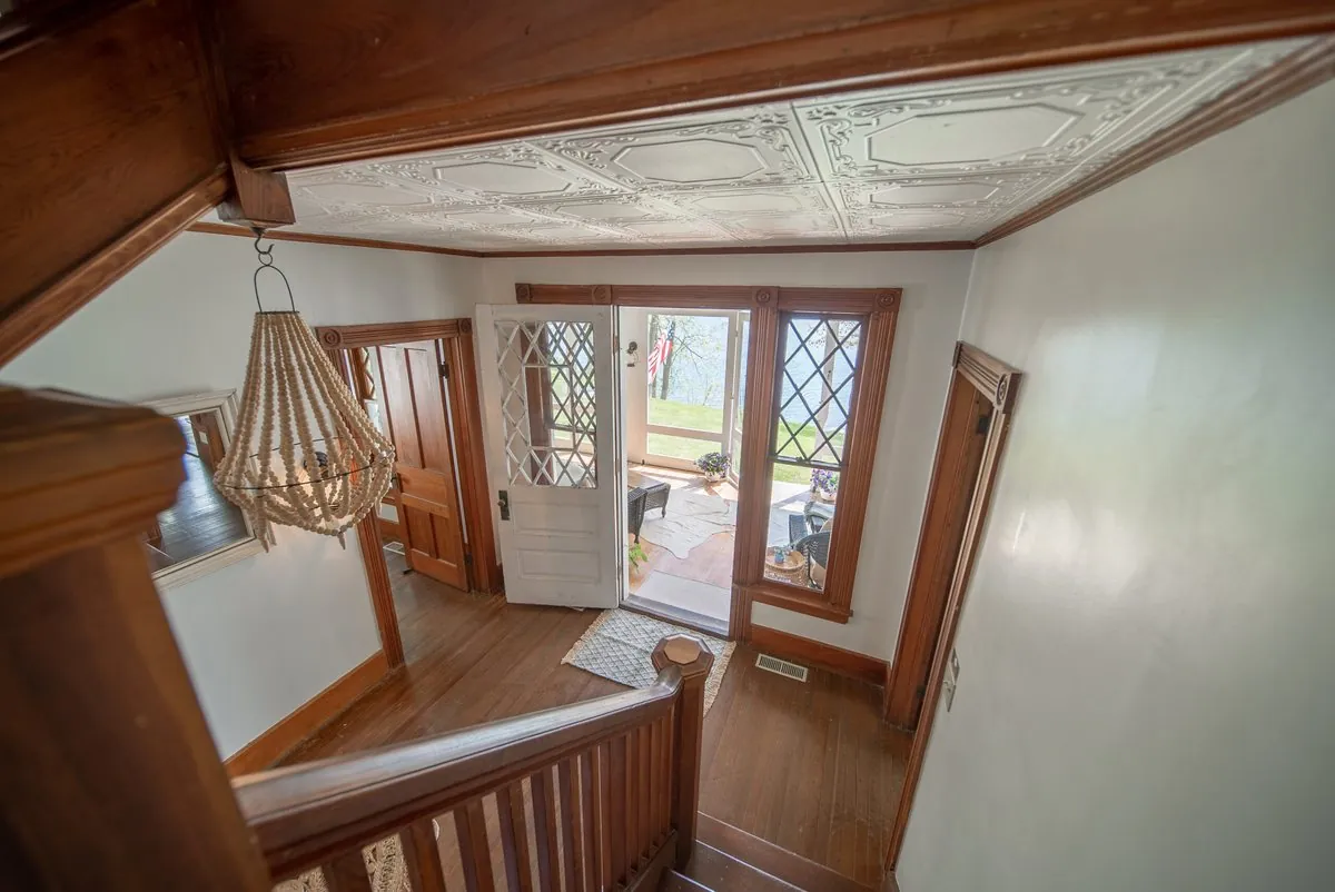 Entry hall with a pressed tin ceiling and the original front door