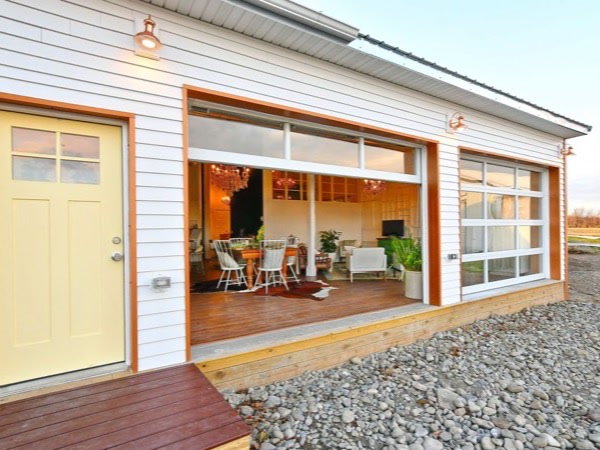 The big glass barn door rolled open at Highbanks, the living room lit up inside