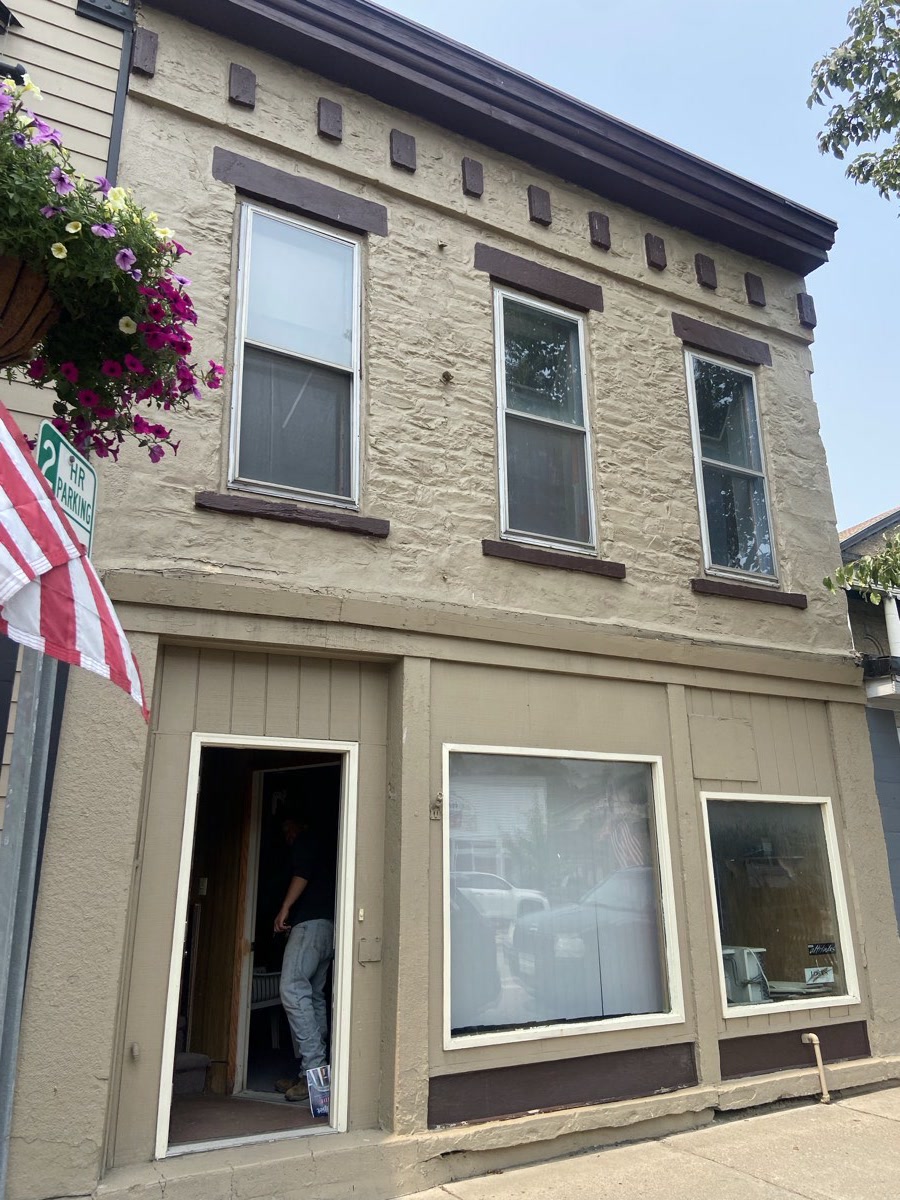 The front of the Main Street building in Perry, door propped open