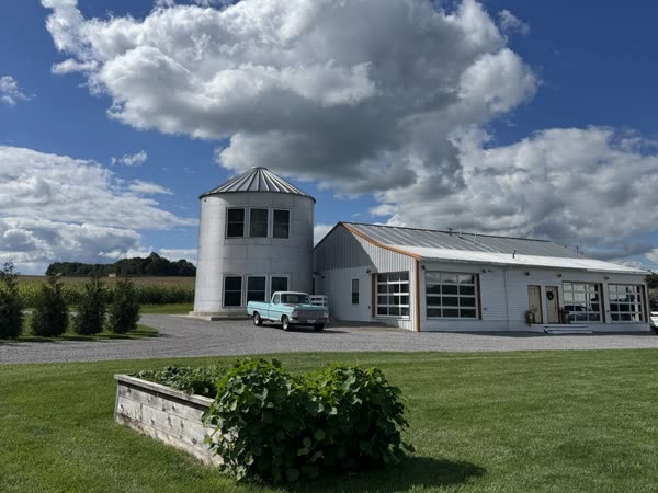 The West Barn and its silo under a big blue sky